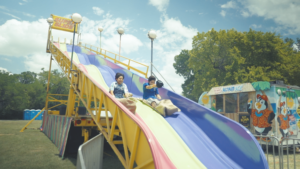 Kids riding slide at Deutschen Pfest